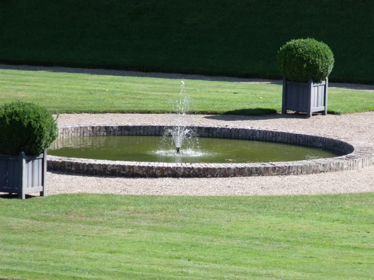 the fountain is built in the center of the lawn