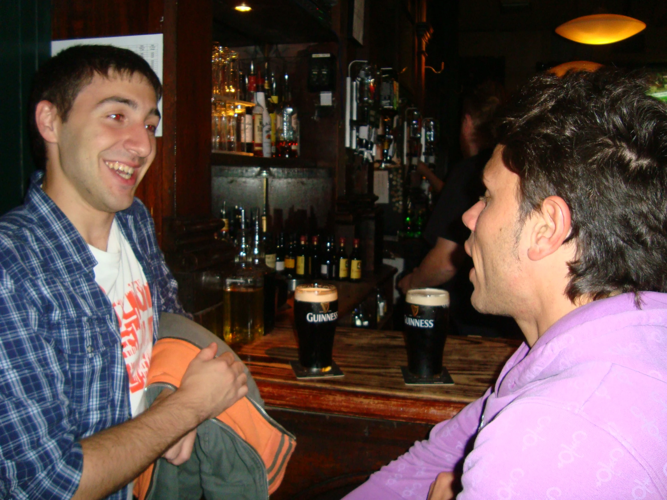 a man standing near another man holding a paper towel