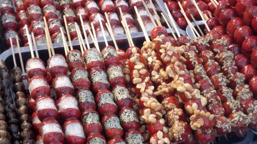 apple candies and marshmallows sit in the middle of trays of candy