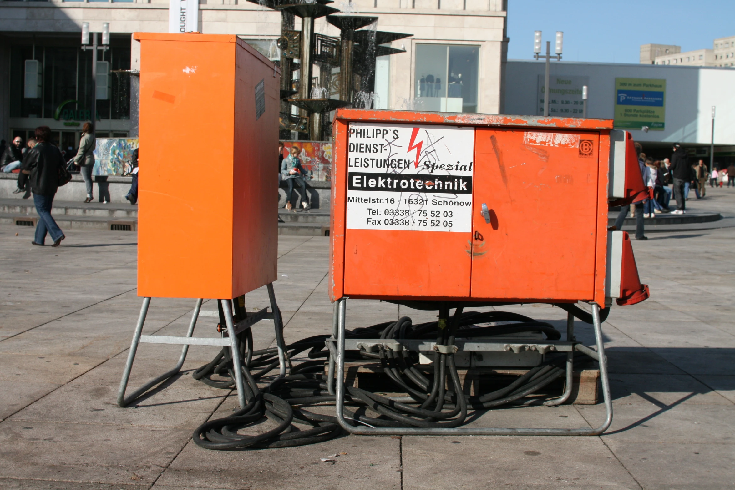 a couple of orange utility crates and black boots