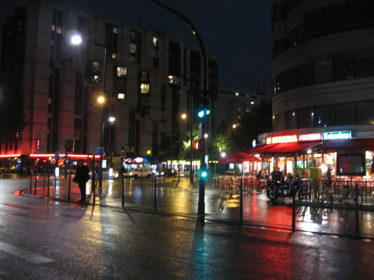 an empty city street at night lit up with lights