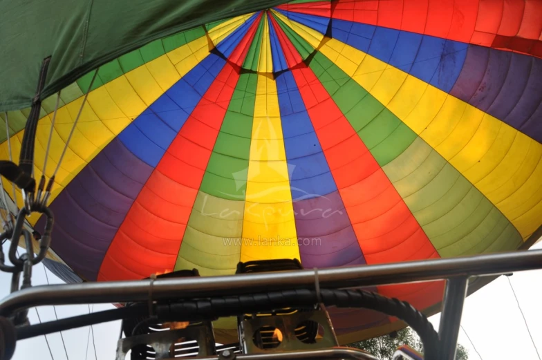 a rainbow colored  air balloon being inflated