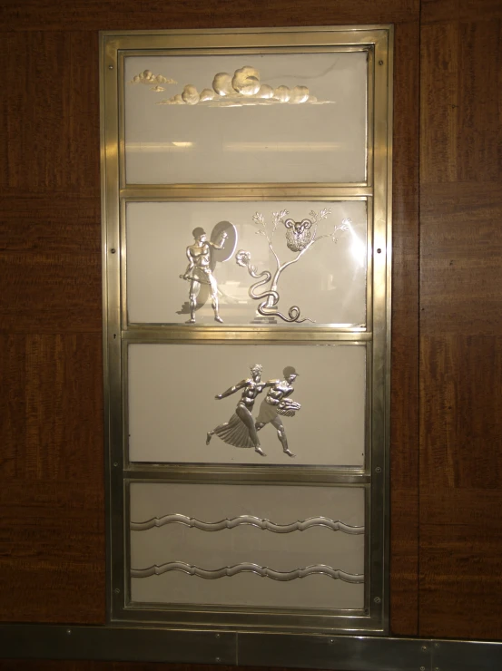 three glass trophies sit against a wooden background