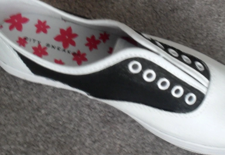 the shoes has black and red designs on them