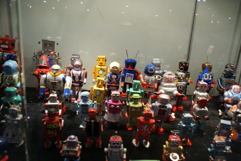 several toys lined up in a display case