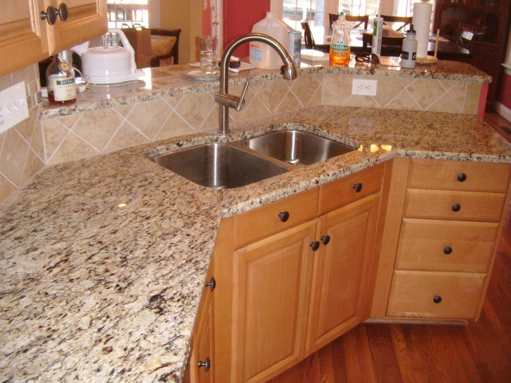 a kitchen counter top with granite and wooden cabinets