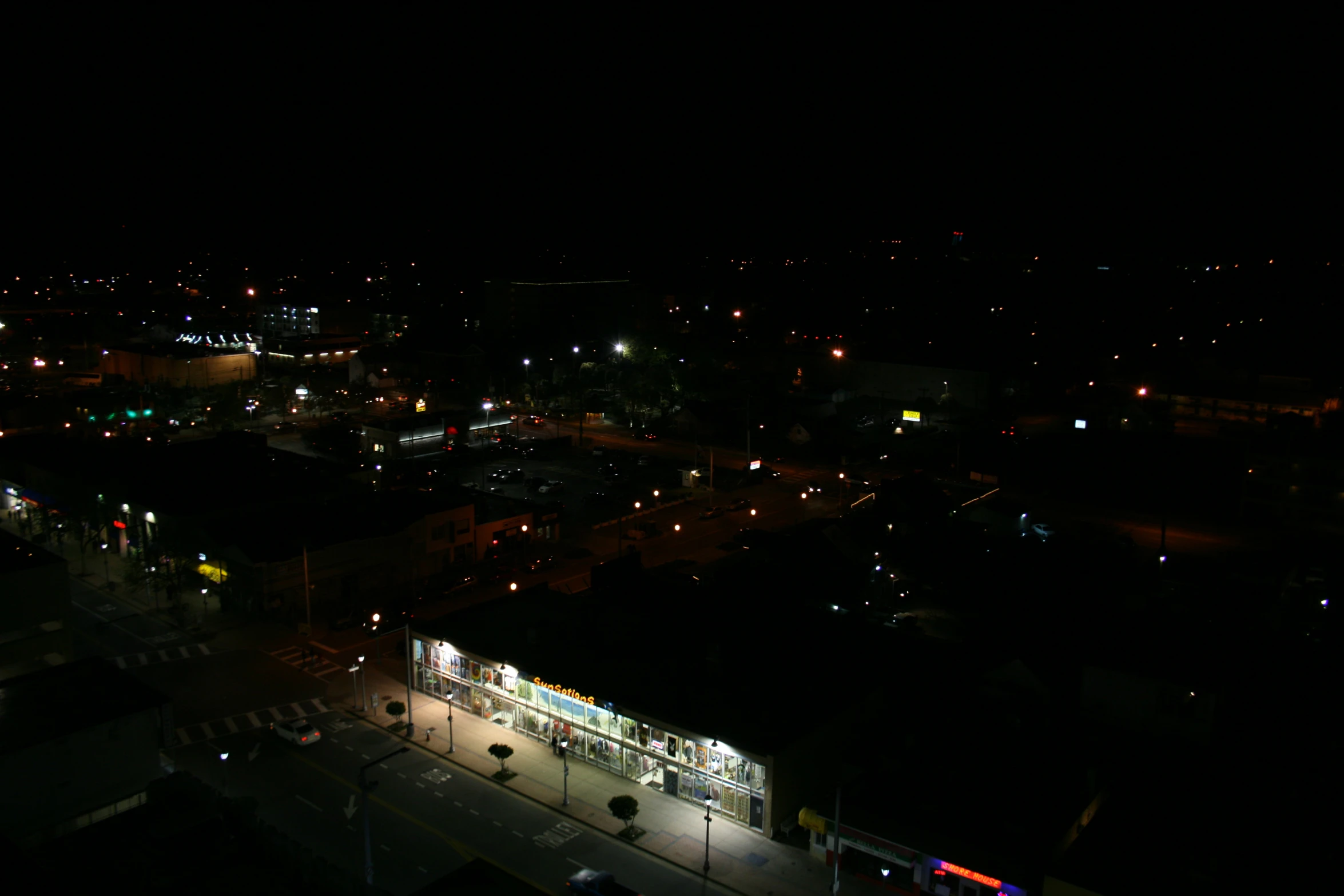 the view from an airplane shows the city lights at night