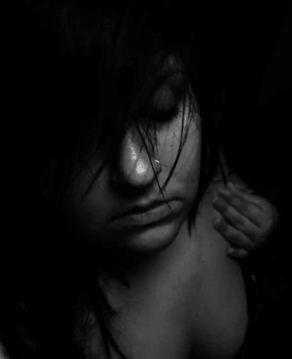 a woman with long hair has her face obscured by the shadows