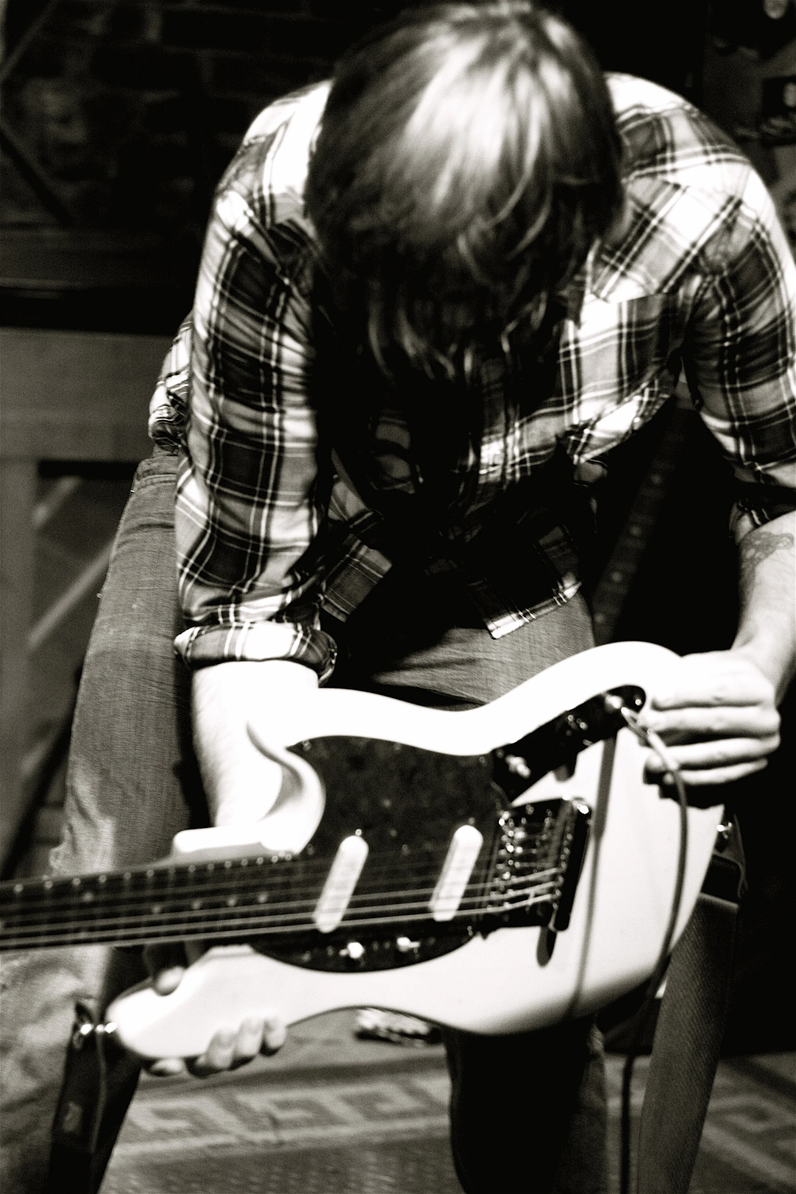 young man posing holding an electric guitar