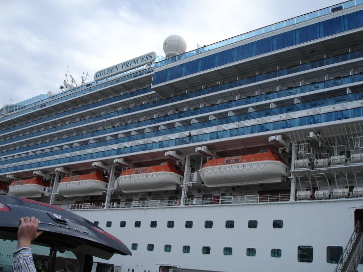 a man standing next to an cruise ship