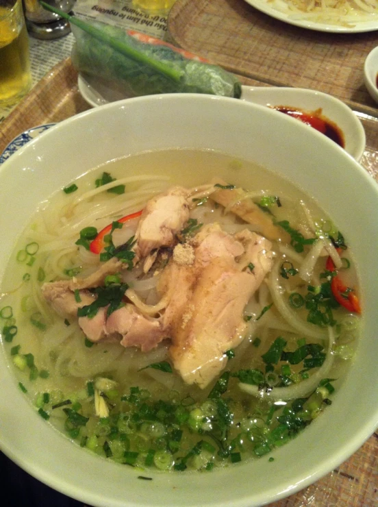 soup and vegetables are in a white bowl