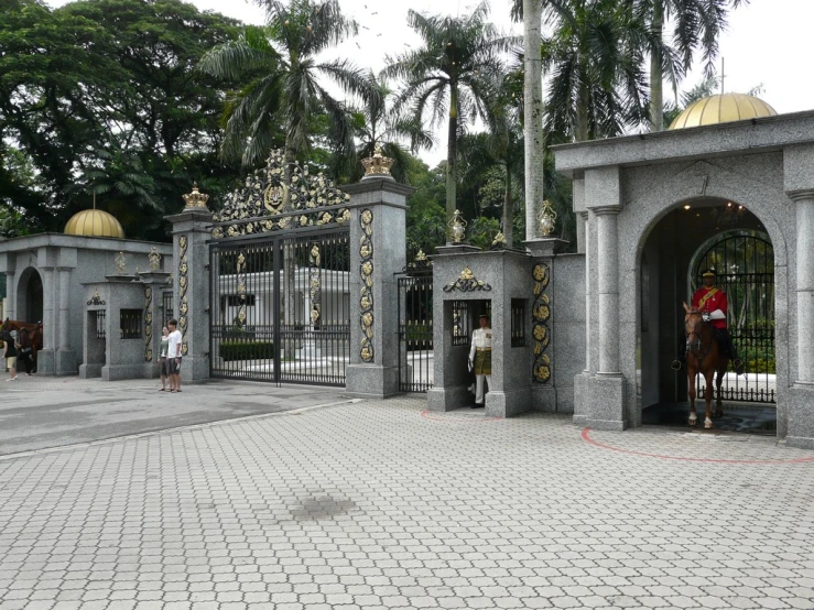 this is a statue of a horse in a stone garden gate