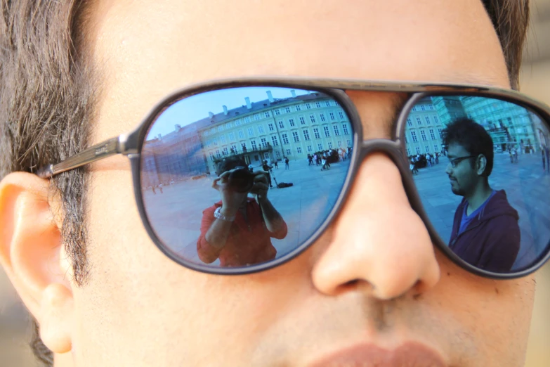 a man with some reflection in his sunglasses