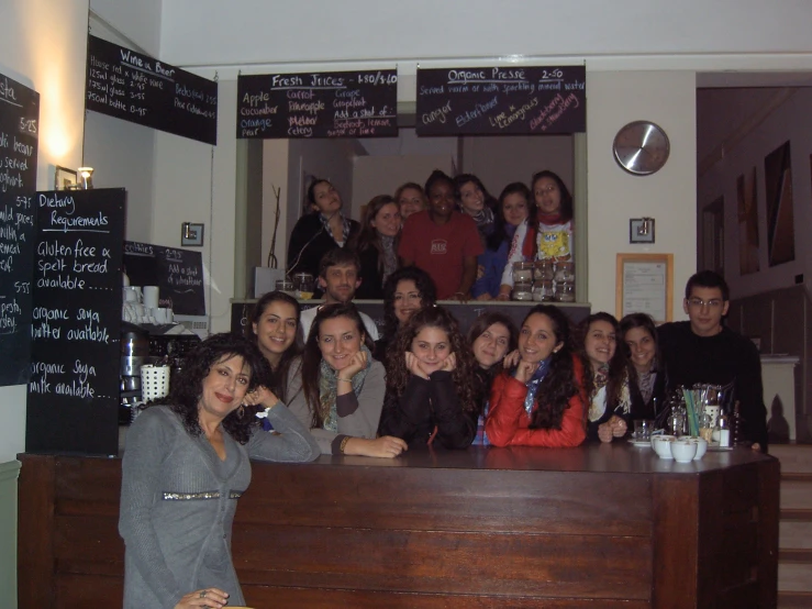 group of young people sitting at a table with beverages