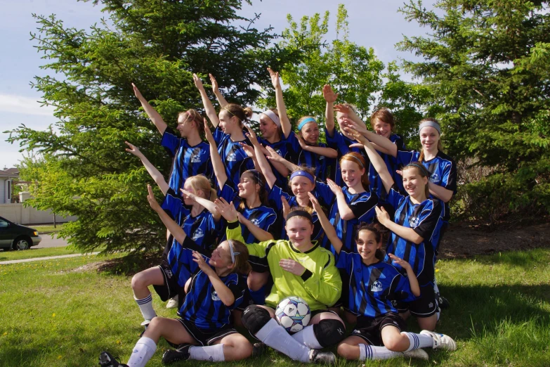 a team po of s in blue and green soccer uniforms