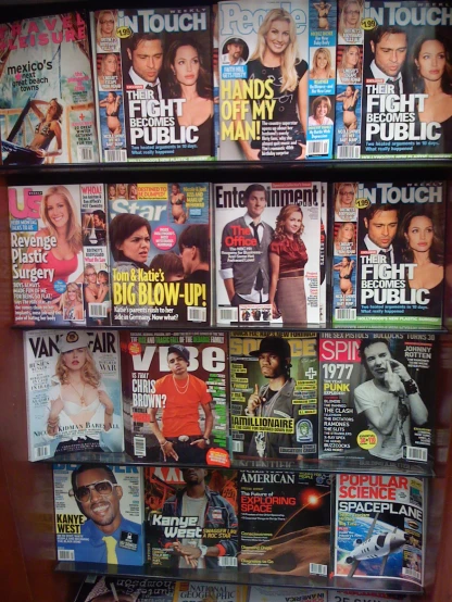 a wall covered with different magazines sitting next to each other