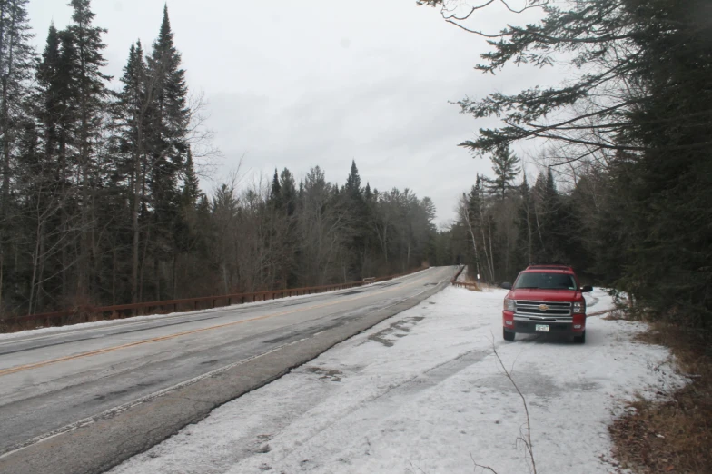 a car traveling down a highway in the middle of winter