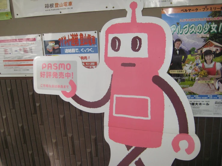 sign showing a pink robot pointing at a magazine