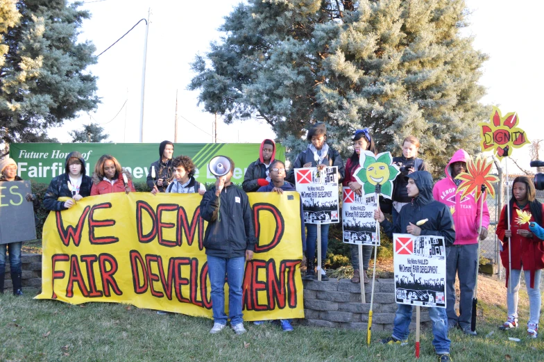 a group of people holding a demonstration sign