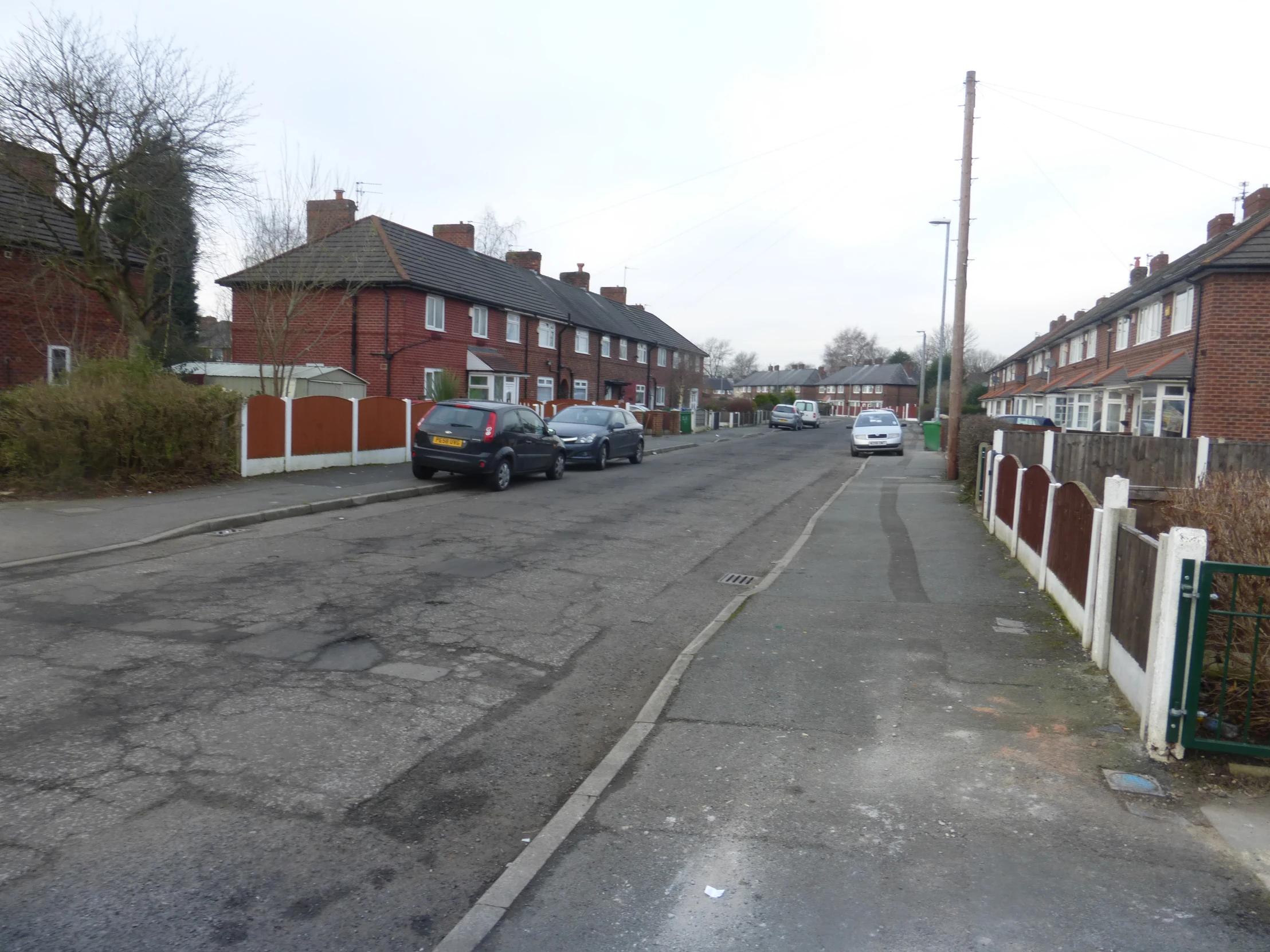 a street with some cars parked along side it