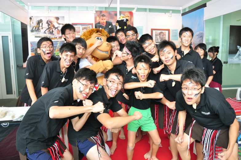 people are posing for a picture in front of a character mascot