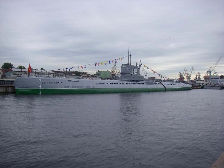 a large green and white boat sitting on the water