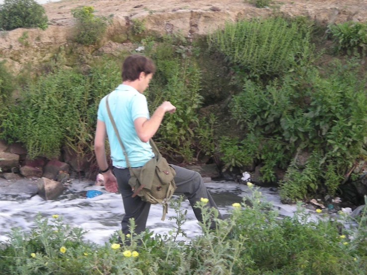 a man walking in the mountains with a backpack