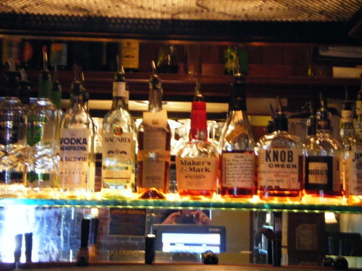 there are many different bottles in the bar