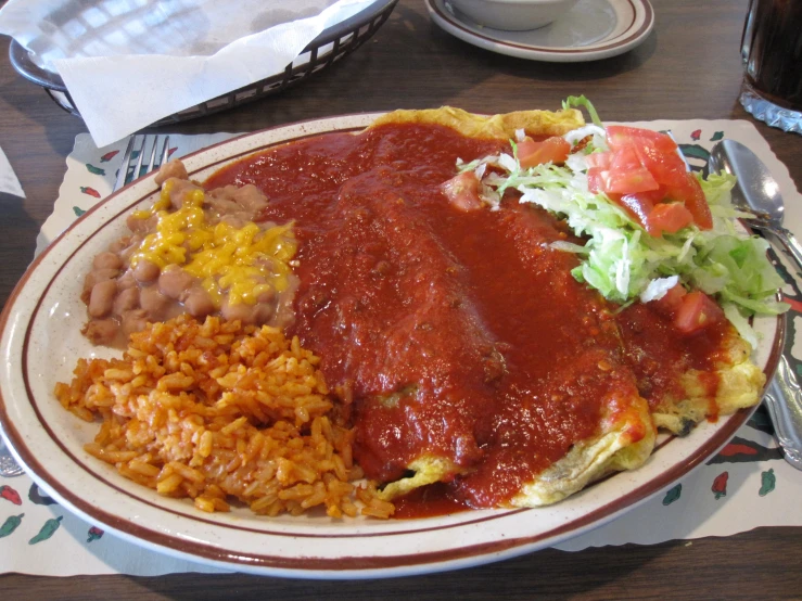 plate of mexican food with salsa and rice on the side
