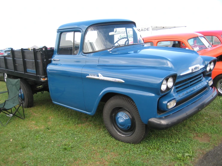 an old pick up truck parked on grass