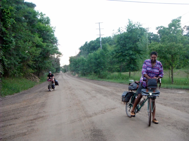 people on bikes and one motor bike on the side of a road