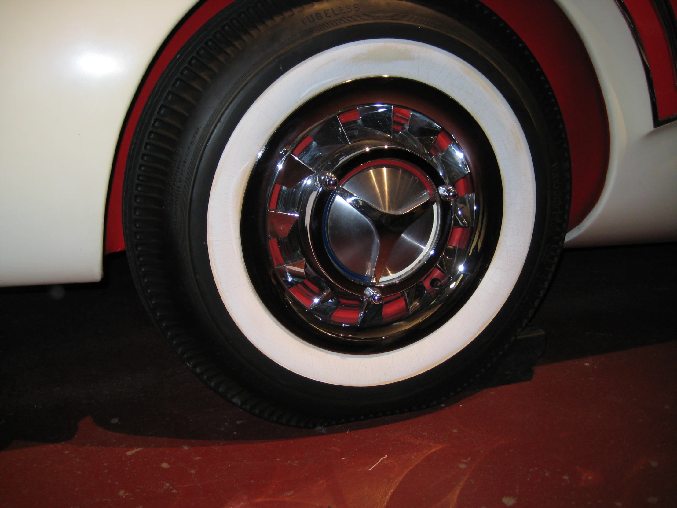 the white tire of the small, elegant vehicle