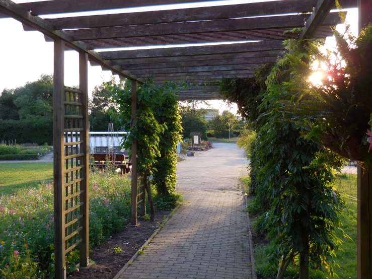 a walkway near a stone and wooden structure