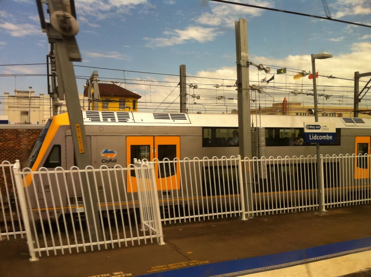 a train is stopped by the gate of a railway station