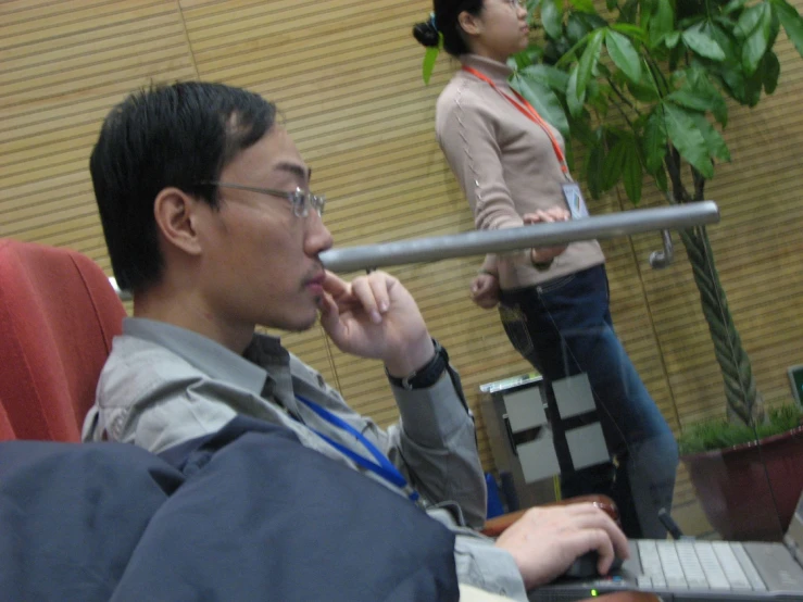 two young asian men are at a desk