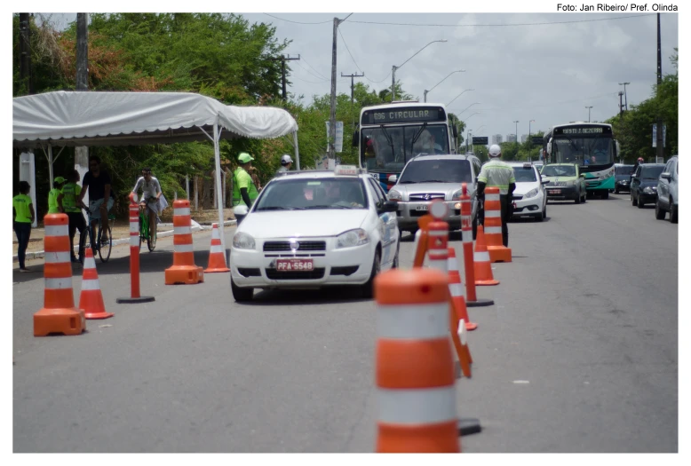 a white car and several orange traffic cones