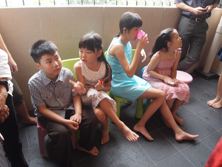 a group of small children sit next to each other