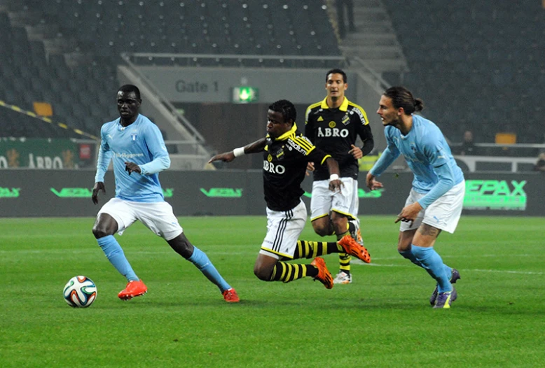 the men are playing a soccer match on the field