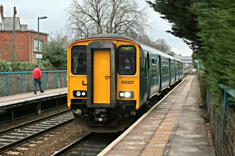 yellow train pulled up to the station at the platform