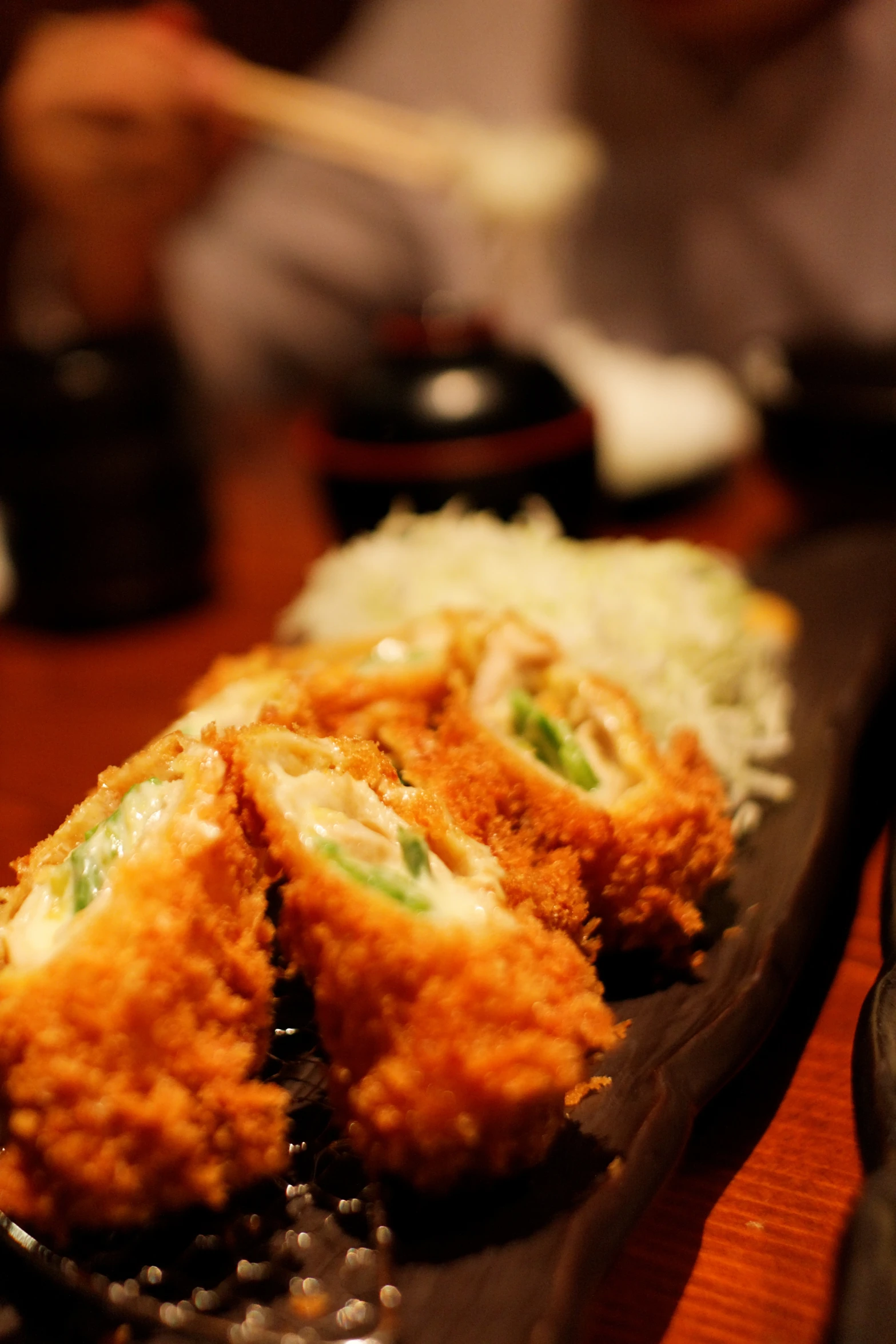 several chicken sticks on a platter being served