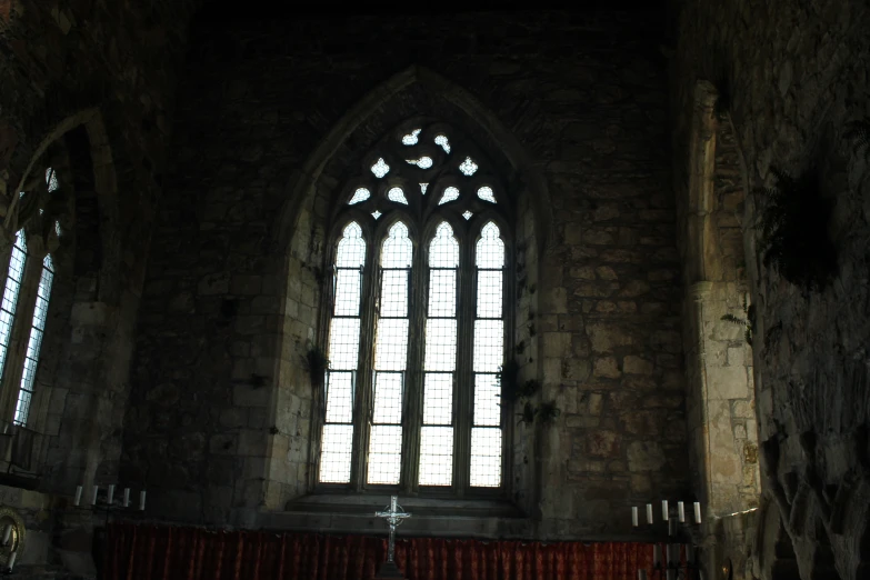 the window of a large stone church is closed