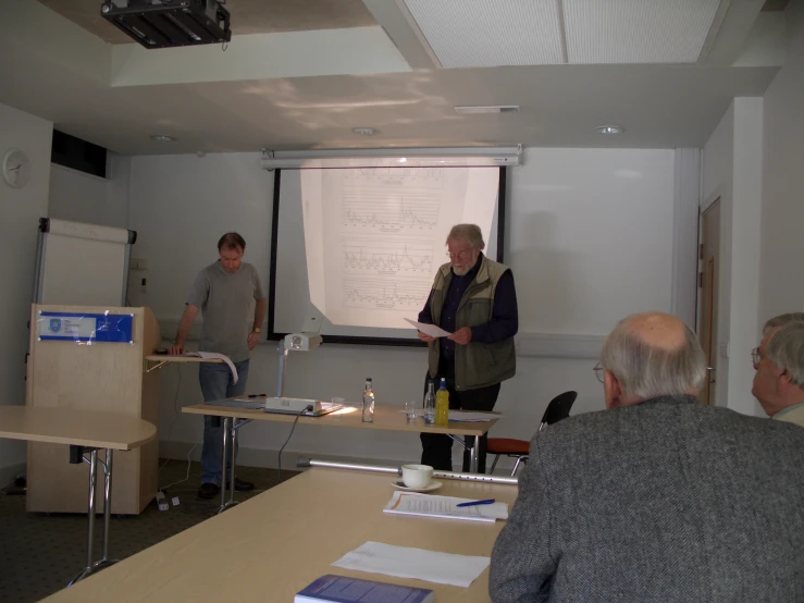 people are standing in a classroom with whiteboard