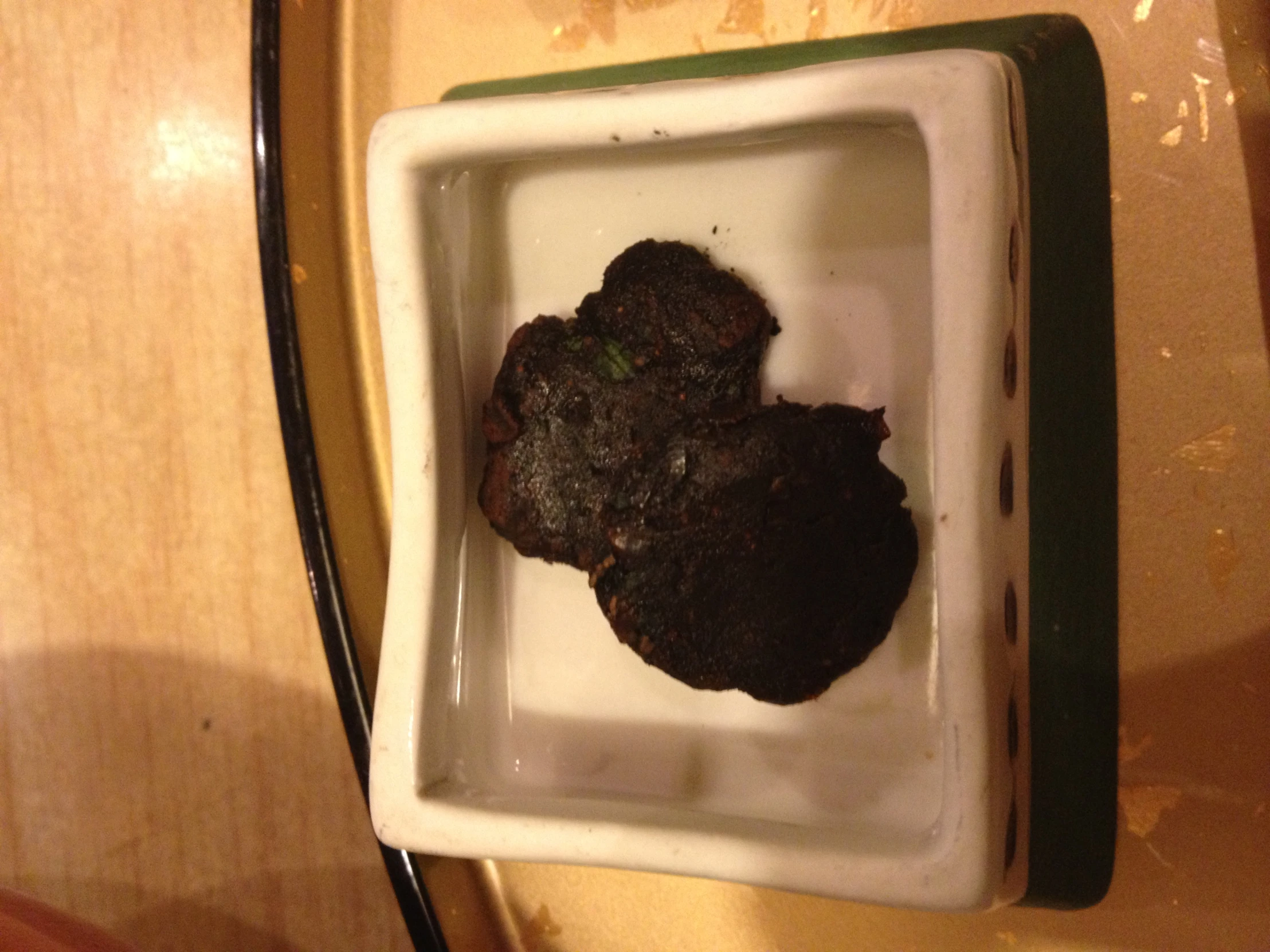 a group of three cookies are in a dish