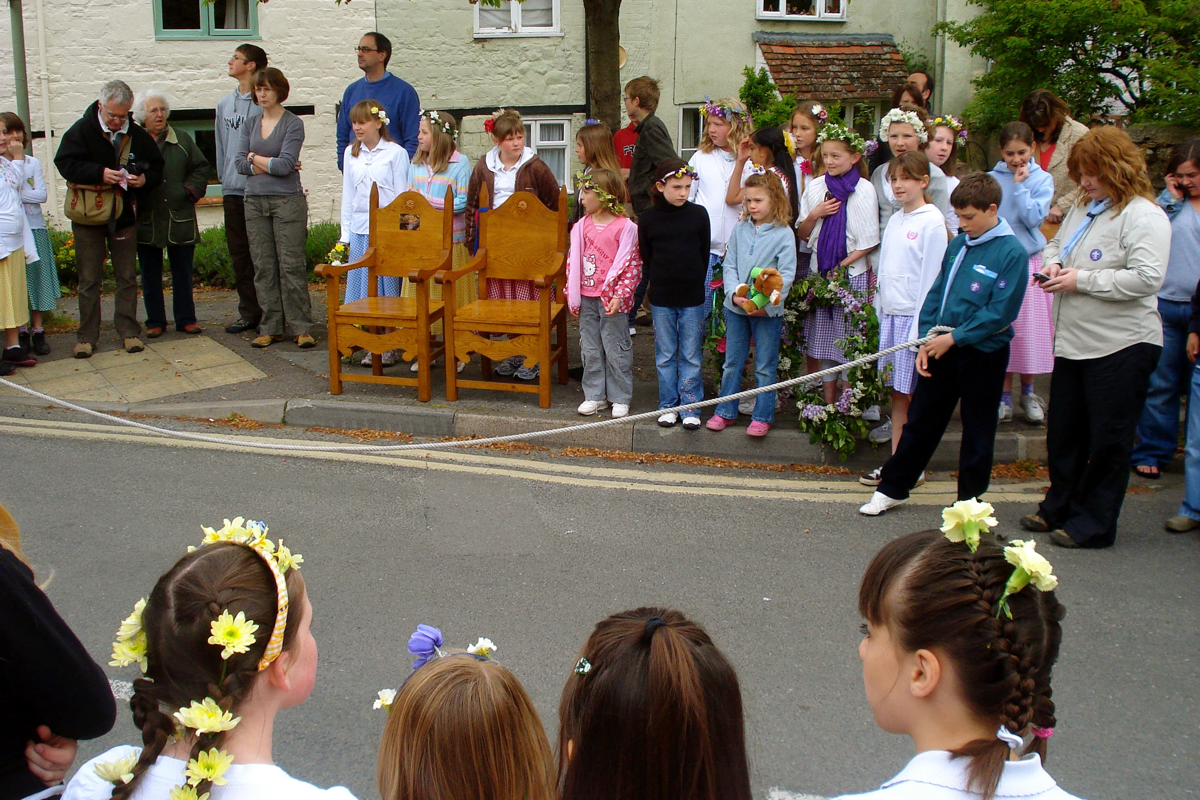 a man on stage surrounded by children at a celetion