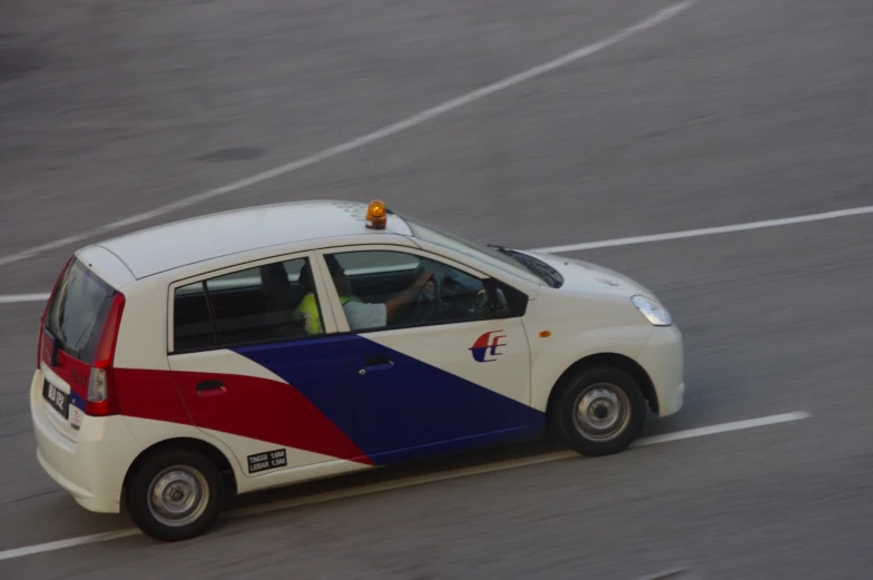 there is a small car with blue and red stripes