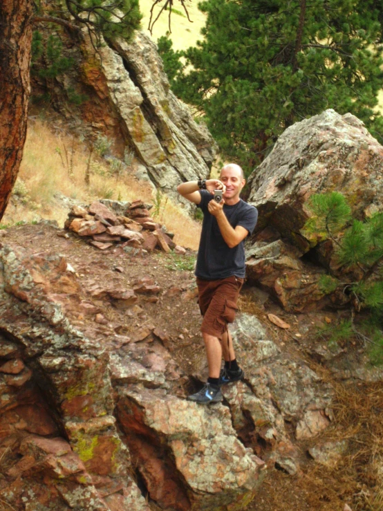 the man is taking a picture of himself in a nature setting