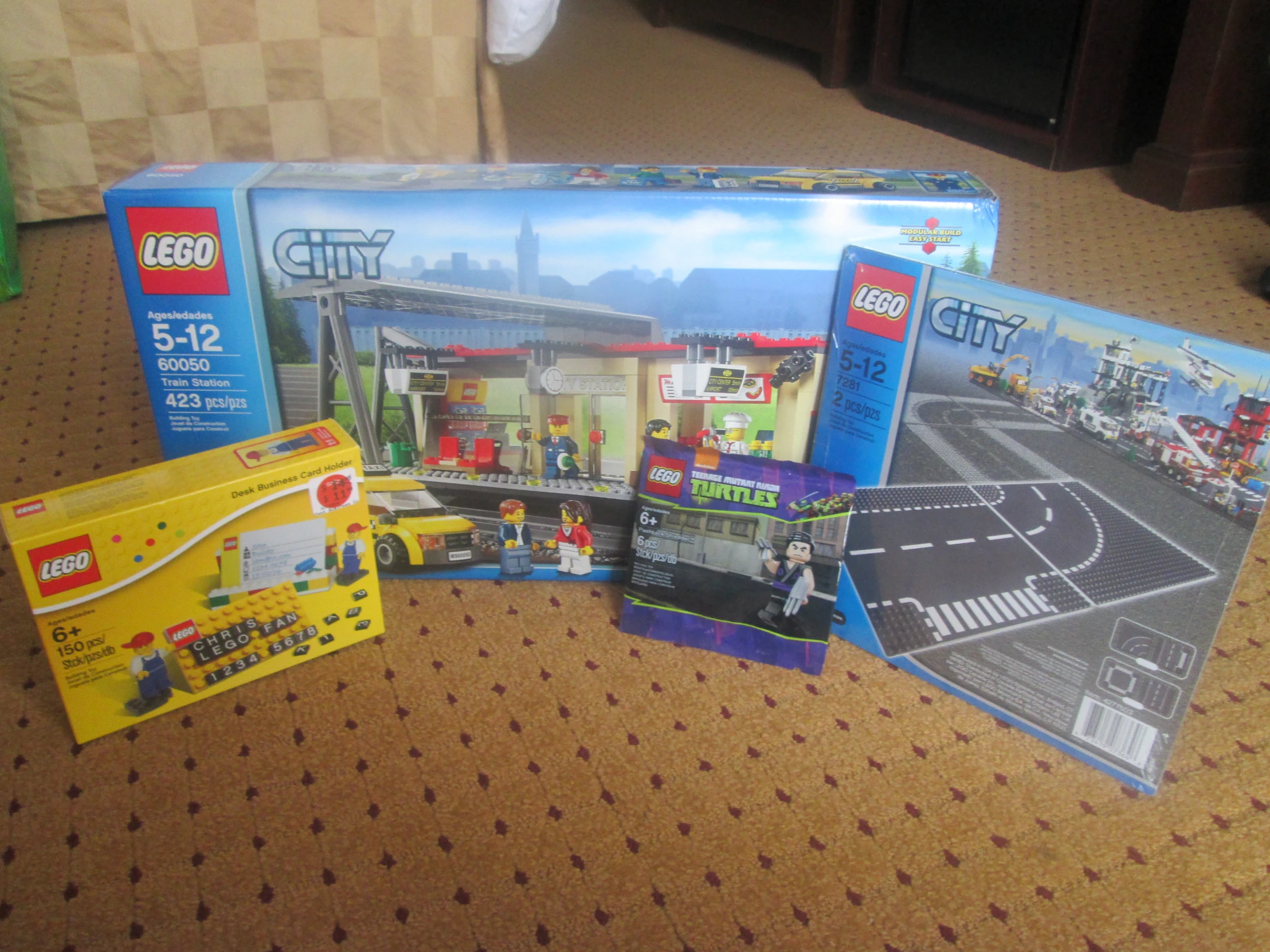 a group of four boxes and a box with some legos inside