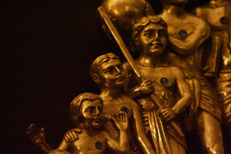 statues depicting jesus holding a sword and two people