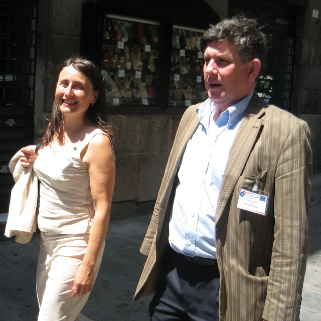 a man and woman are walking down a street