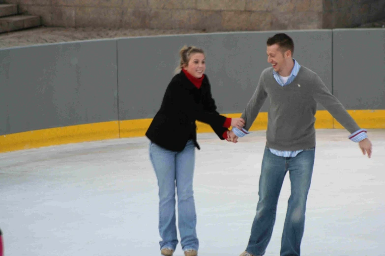 a man and a woman holding hands skating